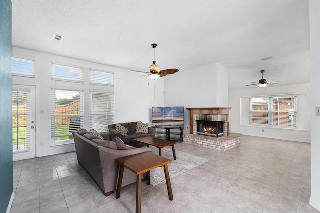 living area featuring plenty of natural light and ceiling fan