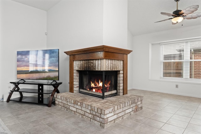 tiled living area featuring a ceiling fan, baseboards, vaulted ceiling, and a fireplace