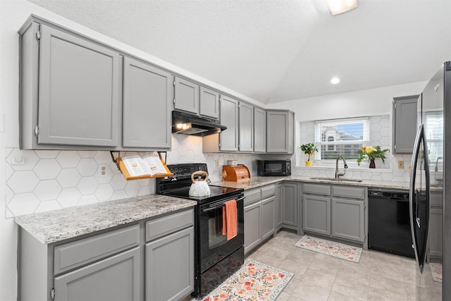 7129 Dee Cole Dr, The Colony, TX 75056 - kitchen with black appliances, gray cabinetry, vaulted ceiling, recessed lighting, and a textured ceiling
