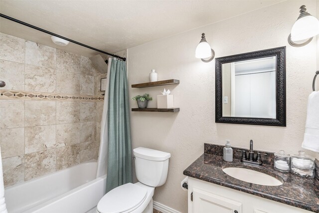 bathroom with vanity, baseboards, shower / bath combo, and toilet
