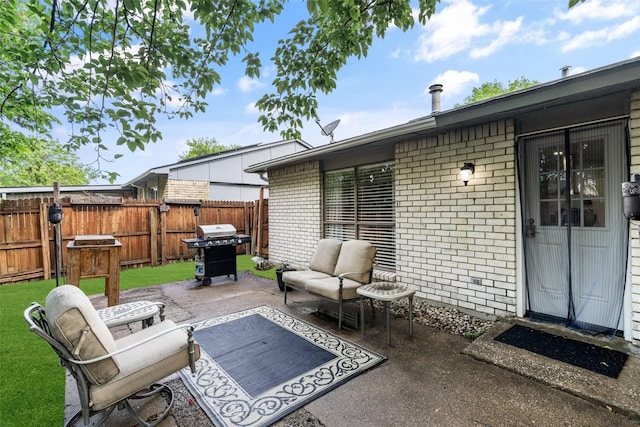 view of patio / terrace featuring an outdoor living space, fence, and a grill