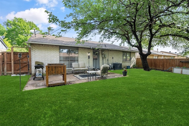 rear view of property featuring a fenced backyard, a patio, central AC unit, and brick siding