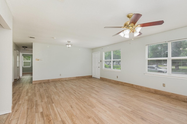 unfurnished room with baseboards, light wood finished floors, and ceiling fan