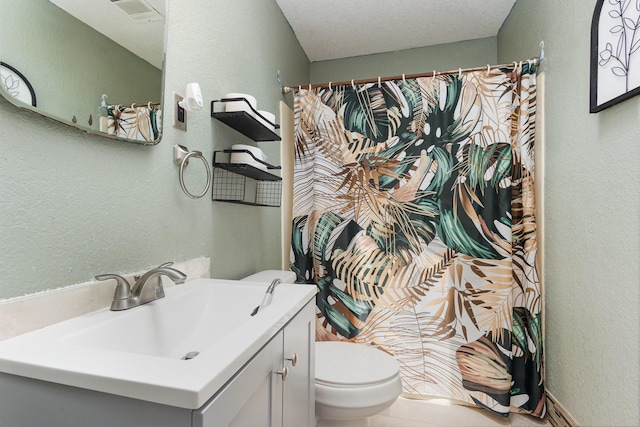 full bathroom with vanity, a textured wall, a shower with curtain, and toilet