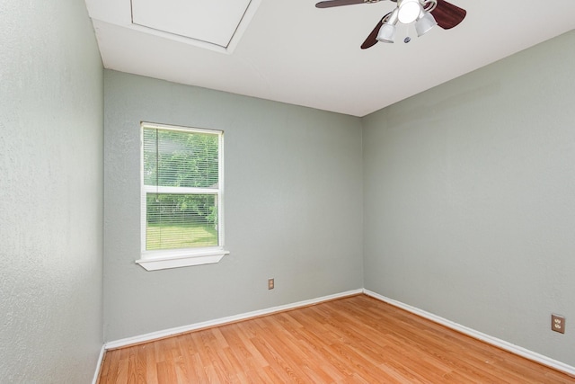 empty room with baseboards, ceiling fan, and wood finished floors