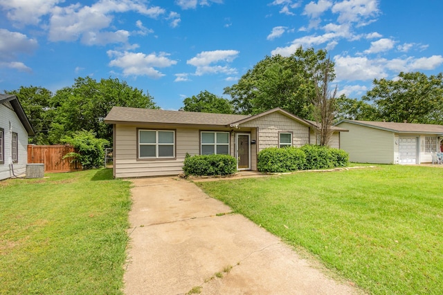 single story home featuring central AC unit, fence, a front yard, and concrete driveway