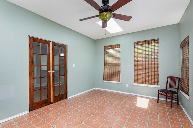 empty room featuring baseboards, ceiling fan, and french doors