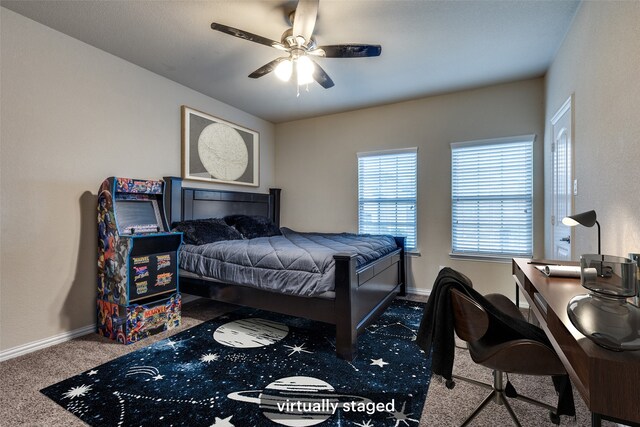 carpeted bedroom with baseboards and ceiling fan