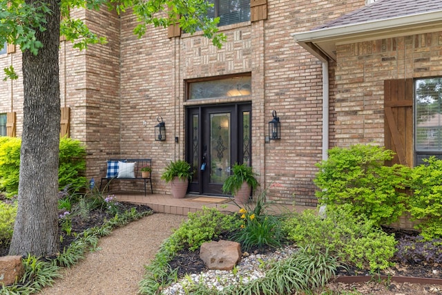 view of exterior entry with brick siding