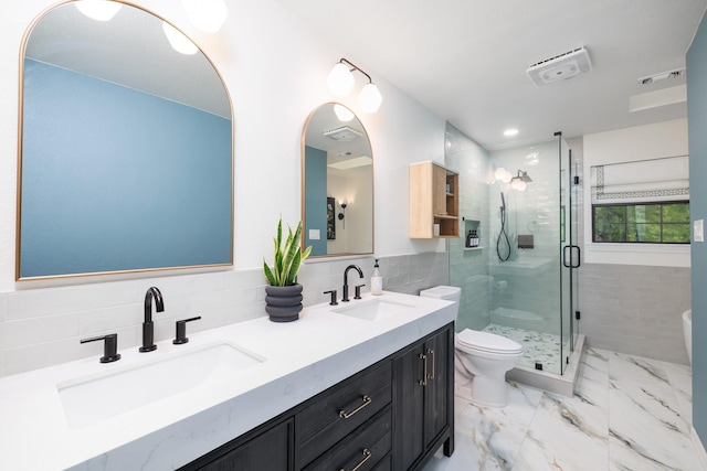 full bath featuring double vanity, toilet, a sink, and a stall shower