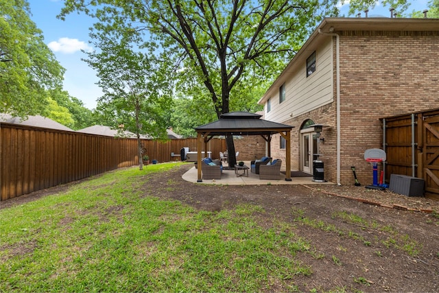 view of yard with a gazebo, a fenced backyard, outdoor lounge area, and a patio