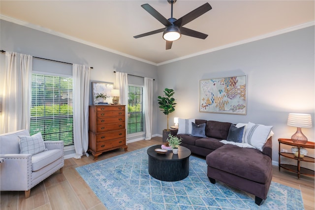 living area with a ceiling fan, baseboards, ornamental molding, and a wealth of natural light