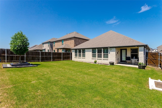 621 Hazeltine Rd, Red Oak, TX 75154 - back of property featuring a lawn, a patio, a fenced backyard, and roof with shingles