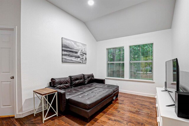 dining area featuring baseboards, dark wood-type flooring, and a raised ceiling