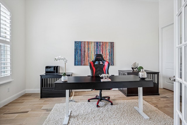 home office with baseboards and wood tiled floor