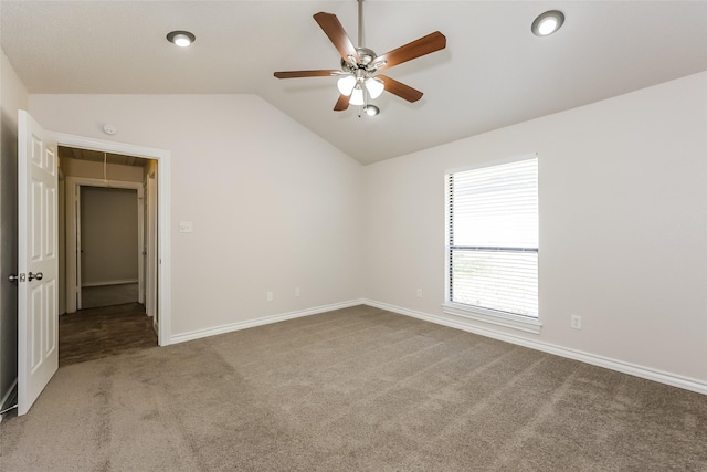 unfurnished bedroom with carpet flooring, baseboards, ceiling fan, and lofted ceiling