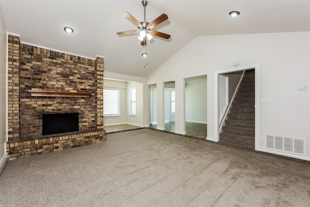 unfurnished living room featuring visible vents, stairs, a fireplace, a ceiling fan, and carpet
