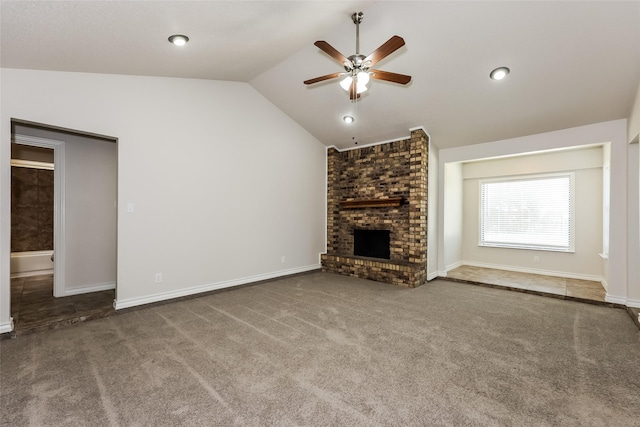 unfurnished living room featuring carpet flooring, a brick fireplace, a ceiling fan, baseboards, and lofted ceiling