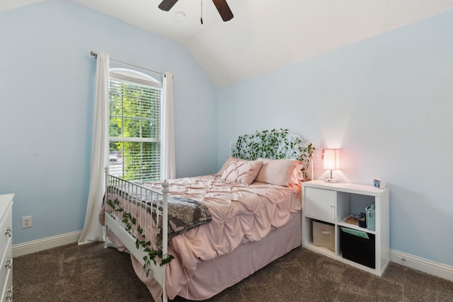 bedroom with a ceiling fan, baseboards, vaulted ceiling, and dark carpet