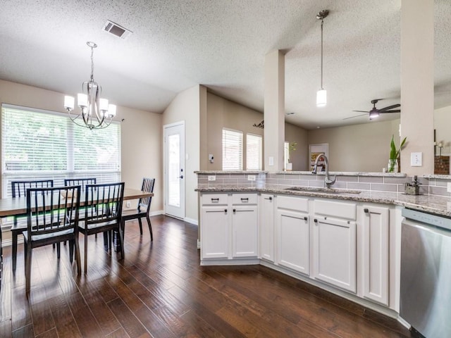 8410 Victory St, Rowlett, TX 75089 - kitchen with dark wood-style flooring, light stone countertops, a sink, stainless steel dishwasher, and visible vents