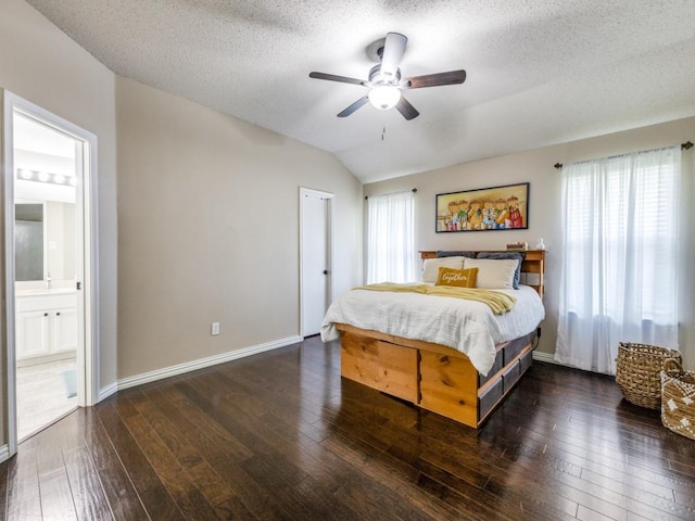 8410 Victory St, Rowlett, TX 75089 - bedroom with a ceiling fan, a textured ceiling, vaulted ceiling, connected bathroom, and hardwood / wood-style floors