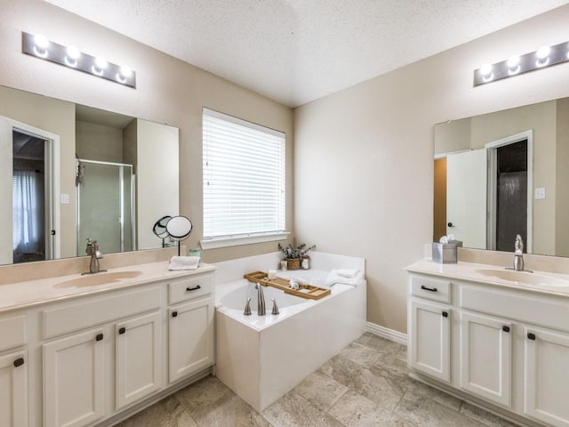 8410 Victory St, Rowlett, TX 75089 - full bath featuring a sink, a textured ceiling, two vanities, and a shower stall