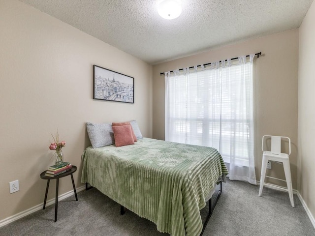 8410 Victory St, Rowlett, TX 75089 - bedroom featuring a textured ceiling, baseboards, and carpet