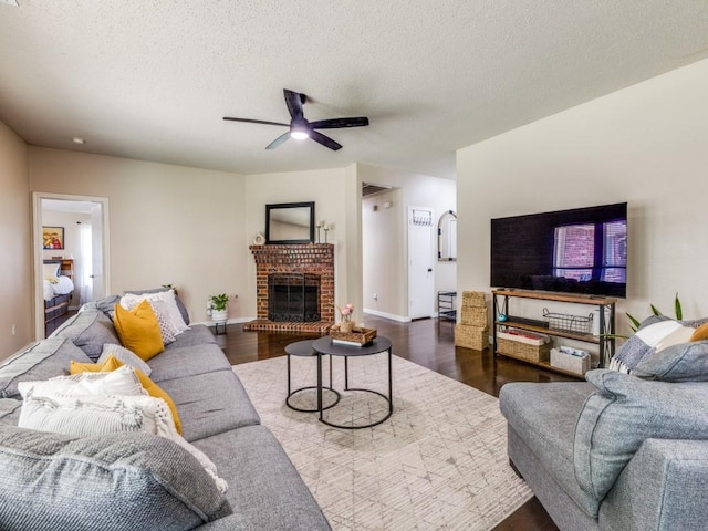 8410 Victory St, Rowlett, TX 75089 - living area with wood finished floors, a fireplace, baseboards, ceiling fan, and a textured ceiling