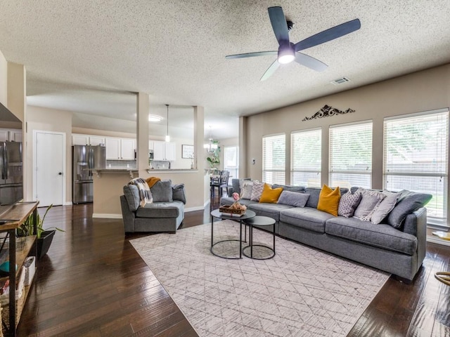 8410 Victory St, Rowlett, TX 75089 - living area with a healthy amount of sunlight, ceiling fan with notable chandelier, and dark wood finished floors