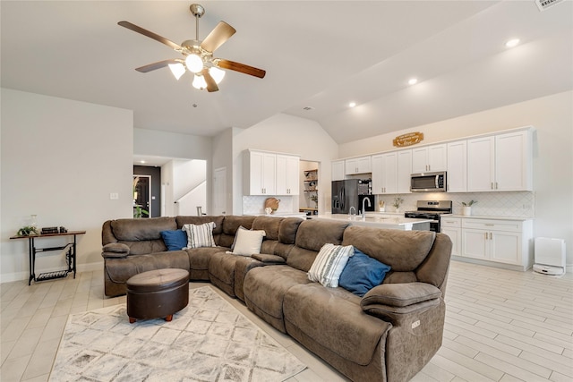 living room with a ceiling fan, vaulted ceiling, recessed lighting, and visible vents