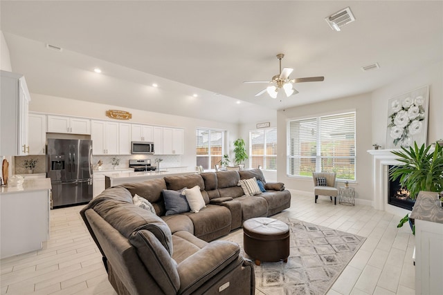 living room featuring ceiling fan, recessed lighting, and visible vents