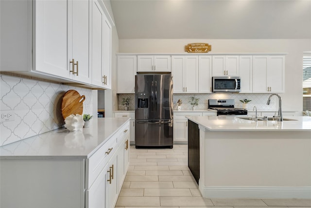 kitchen featuring light countertops, a sink, tasteful backsplash, and stainless steel appliances