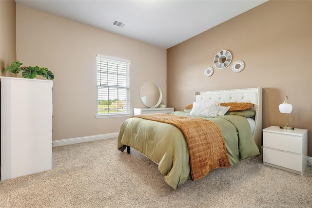 bedroom with carpet floors, baseboards, and visible vents