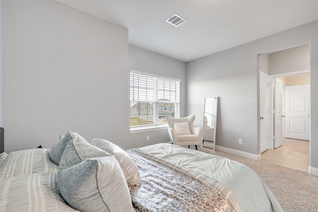 bedroom featuring light colored carpet, baseboards, and visible vents