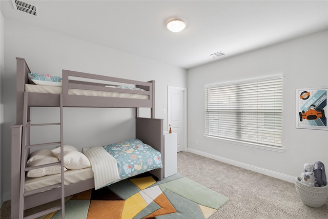 carpeted bedroom featuring baseboards and visible vents