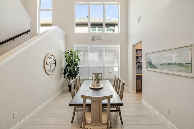 704 Fencerow Trl, Weston, TX 75009 - dining space with a towering ceiling, light tile patterned floors, and baseboards