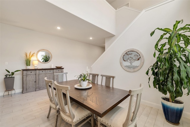 dining space featuring baseboards, recessed lighting, and light wood finished floors