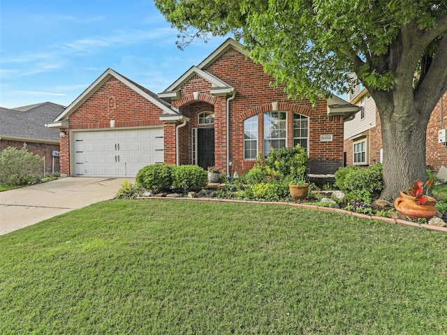 traditional-style house featuring brick siding, an attached garage, driveway, and a front yard