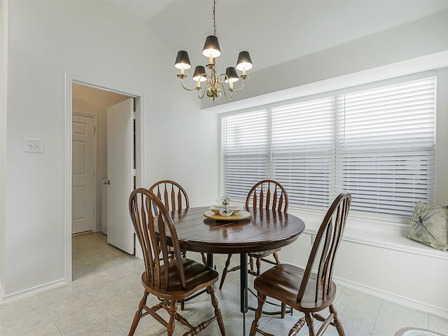dining space with baseboards, an inviting chandelier, light tile patterned floors, and lofted ceiling