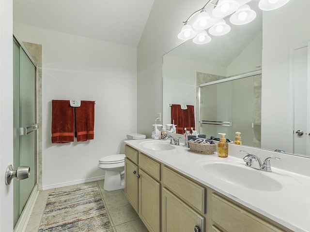 bathroom featuring a sink, a stall shower, vaulted ceiling, and toilet