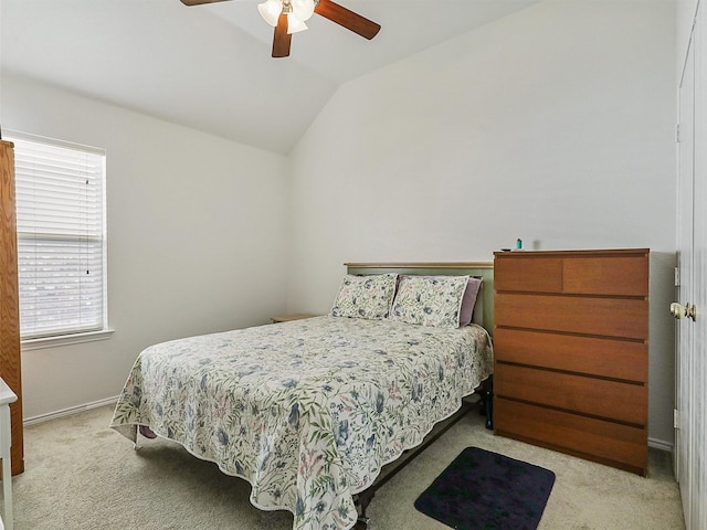 carpeted bedroom featuring baseboards, a ceiling fan, and vaulted ceiling