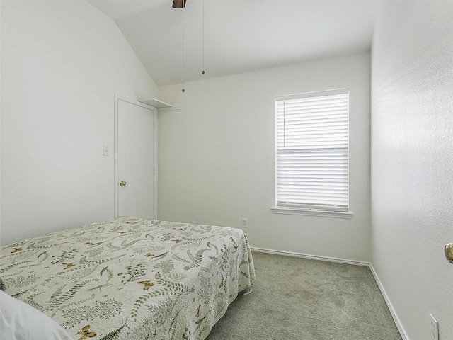 bedroom with baseboards, a ceiling fan, lofted ceiling, and light carpet