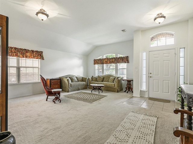 living room with visible vents, baseboards, lofted ceiling, and carpet