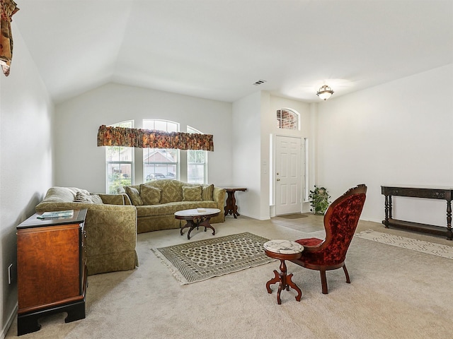 carpeted living area featuring visible vents and lofted ceiling