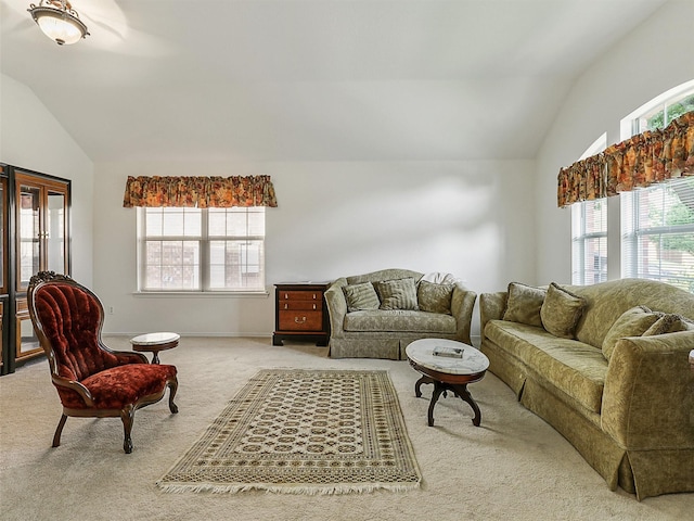 living area featuring light colored carpet and vaulted ceiling