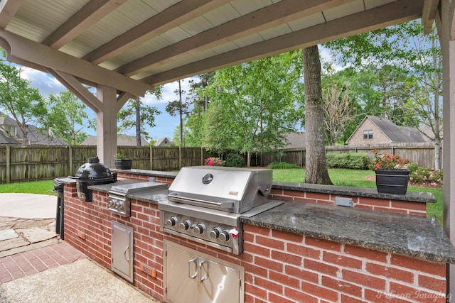 1123 Waters Edge Cir, Shreveport, LA 71106 - view of patio with area for grilling, an outdoor kitchen, and a fenced backyard