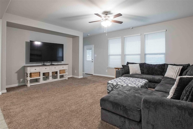 living area with carpet flooring, ceiling fan, and baseboards
