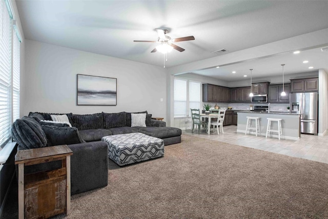 living room with ceiling fan, light carpet, recessed lighting, and visible vents