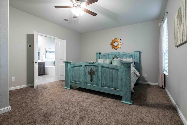 bedroom with visible vents, carpet flooring, connected bathroom, and baseboards