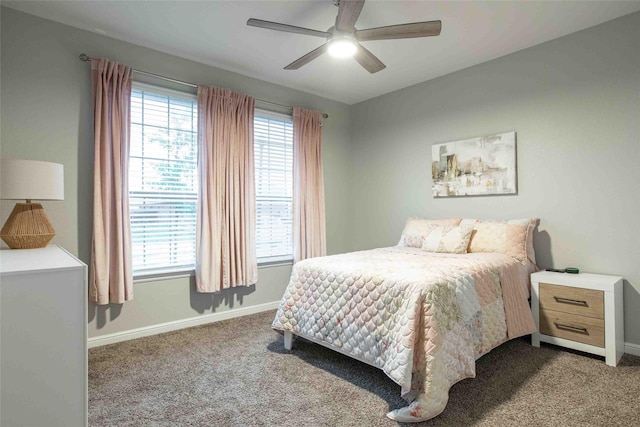 carpeted bedroom featuring baseboards and ceiling fan